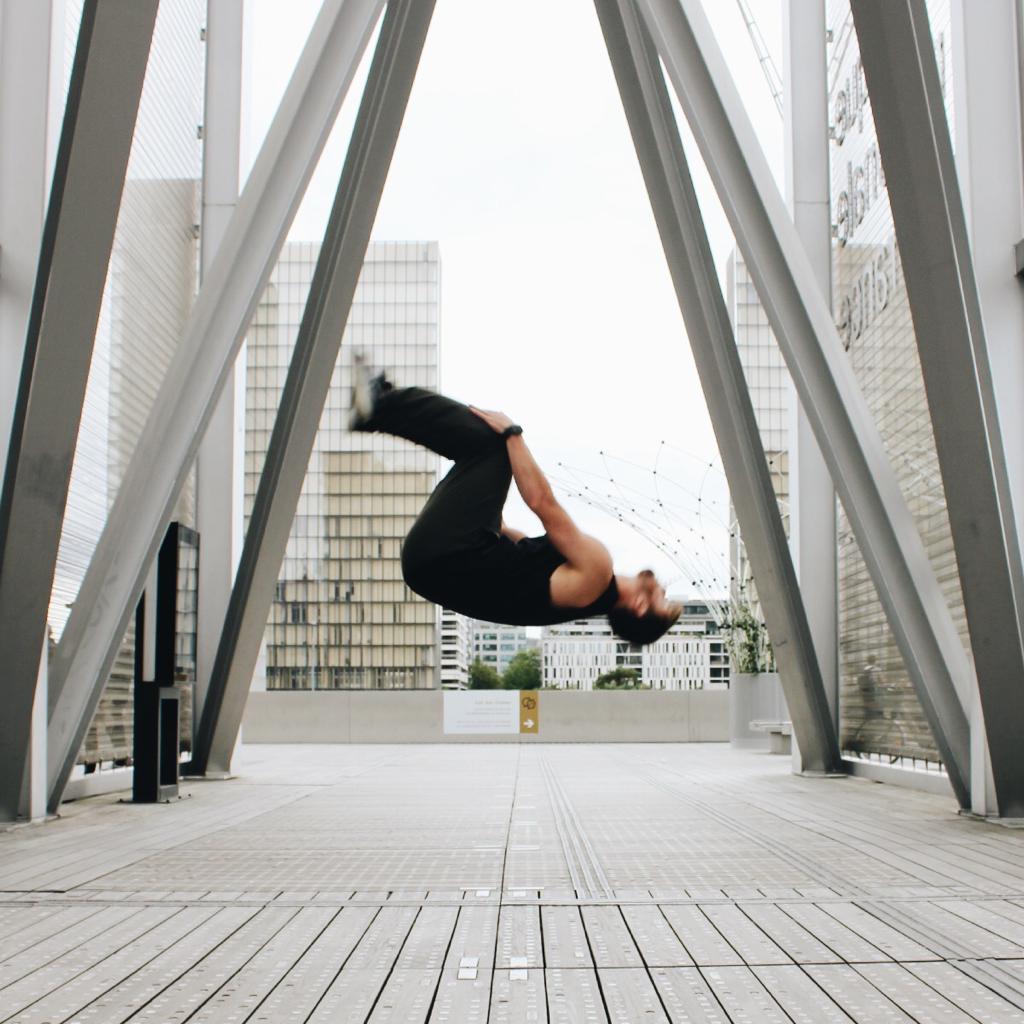 Men doing back flip-