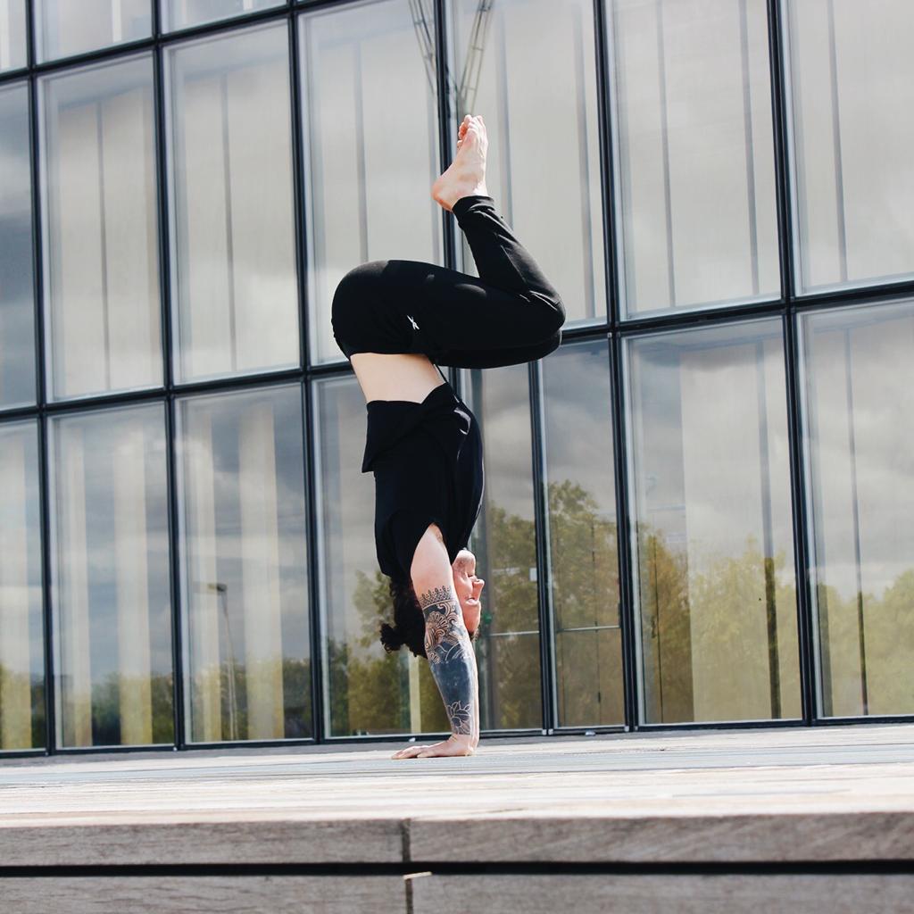 Men doing handstand with bended legs 