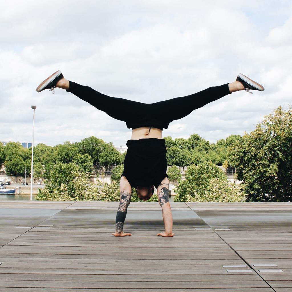 Men doing handstand with open legs